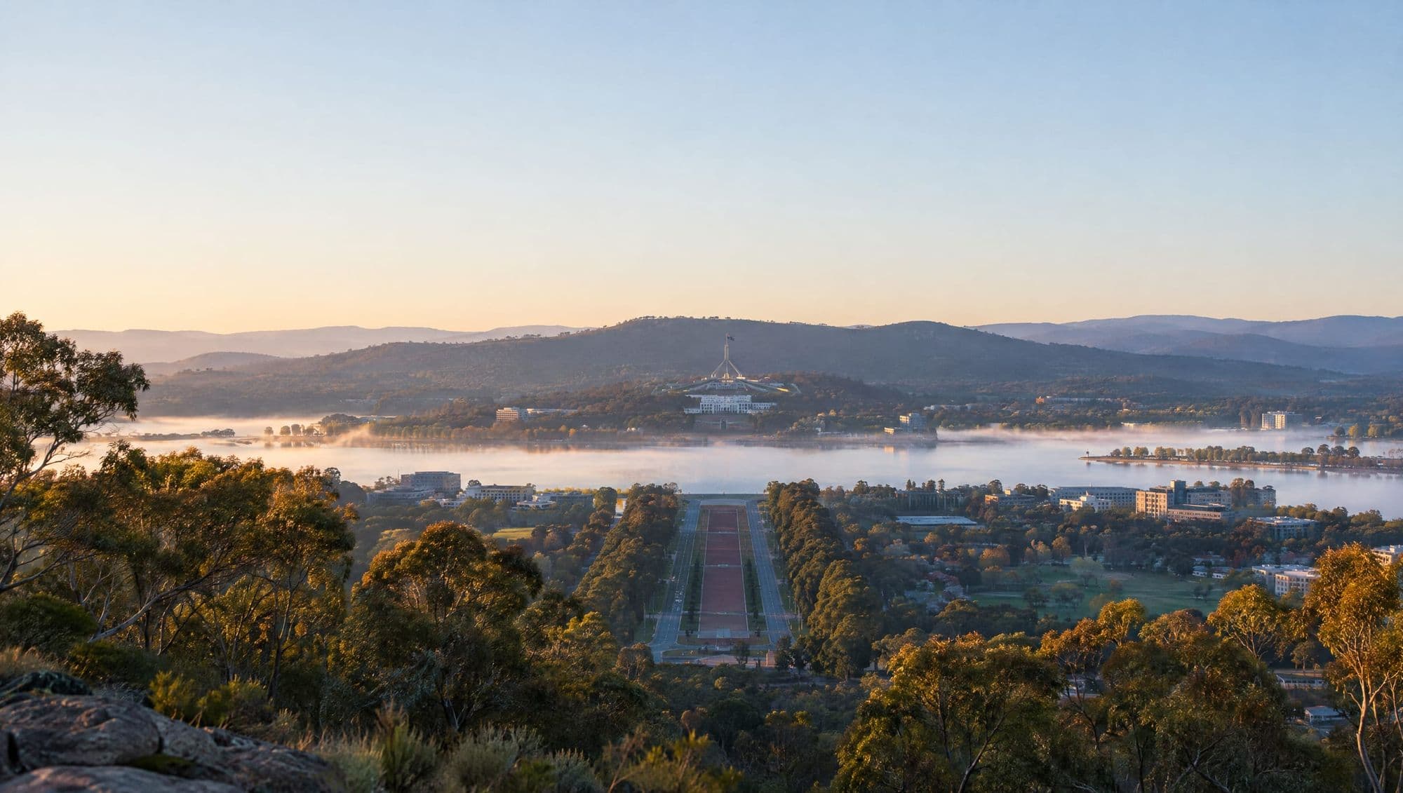 Canberra at dawn from Mount Ainslie, looking down Anzac Parade to Lake Burley Griffin and Parliament House